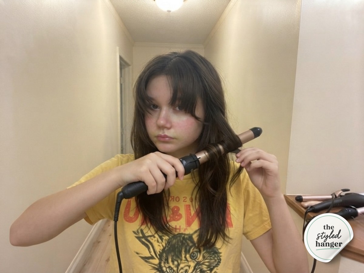 Wrapping sections around a 1-inch curling wand to build waves in a medium length wolf cut